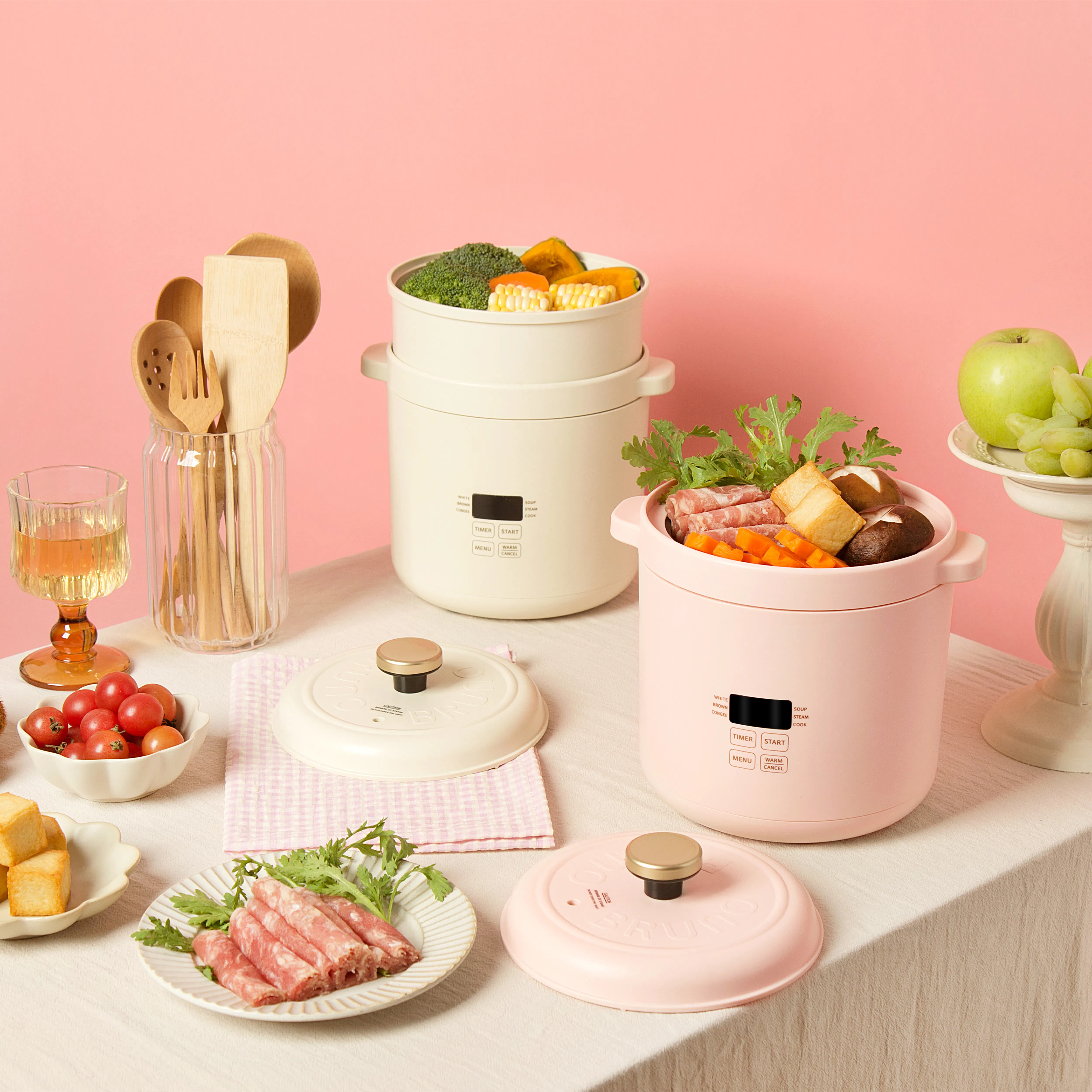 Bruno Mini Rice Cooker - Pink - 11 - Wooden utensils, pink background, food preparation, pink tablecloth, pink crockpot
