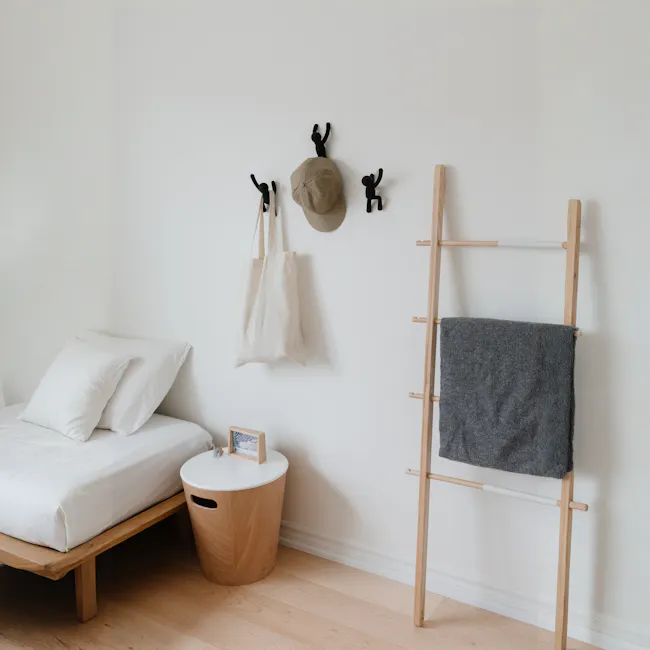 Buddy Wall Hook - Black (Set of 3) - 2 - Wooden nightstand, white round table, gray blanket, wooden ladder, beige tote bag