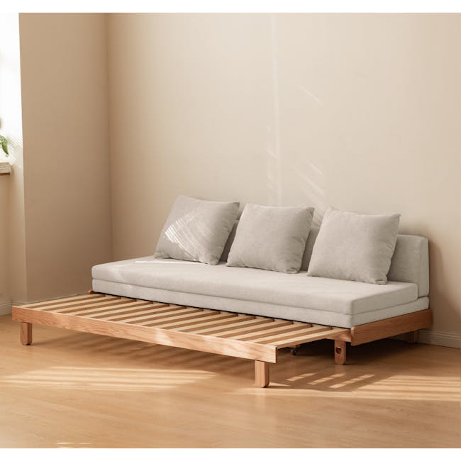 Reese 3 Seater Sofa Bed - Oak, Off White - 6 - Minimalist sofa, light gray cushions, wooden frame, natural light, cozy