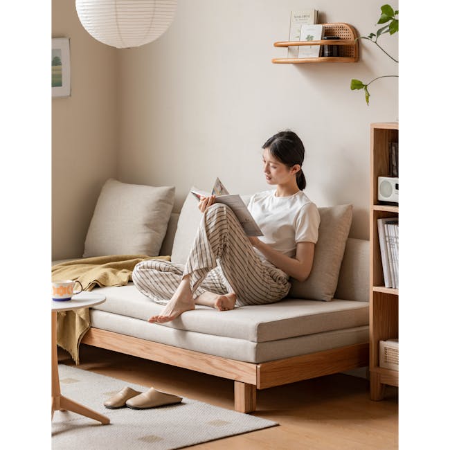 Reese 3 Seater Sofa Bed - Oak, Off White - 5 - Sleek modern living room, cozy reading nook, woman reading book, light beige