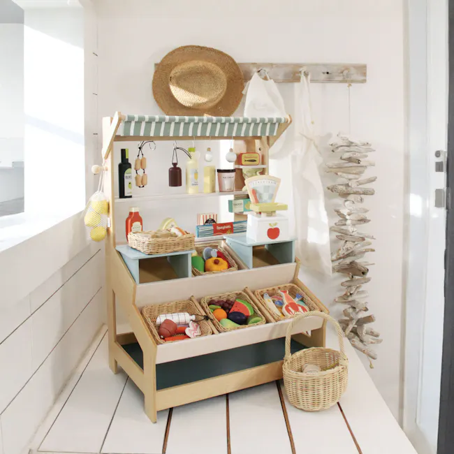 Tender Leaf Toy Kitchen - General Stores - 3 - Wicker kitchen cart with various items, wooden shelf, striped awning, hanging