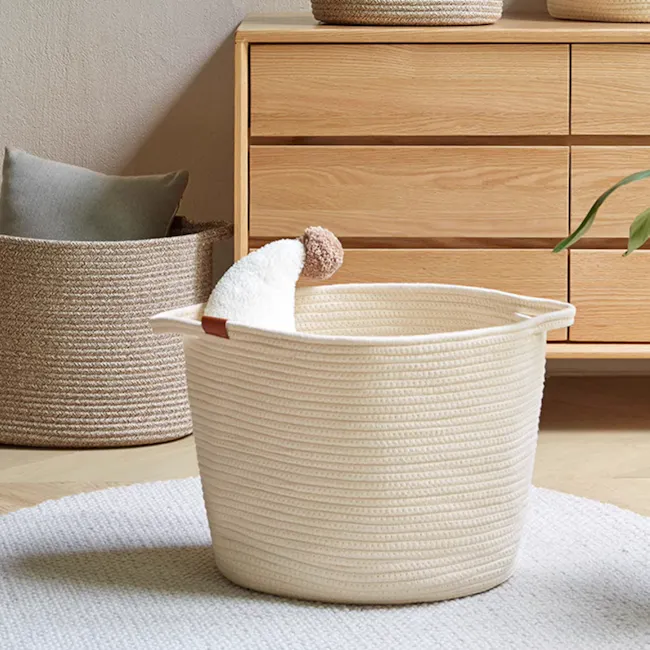 Nisa Rope Laundry Basket - Cream - 4 - Wicker laundry basket, beige interior, cozy setting, natural light, wooden dresser