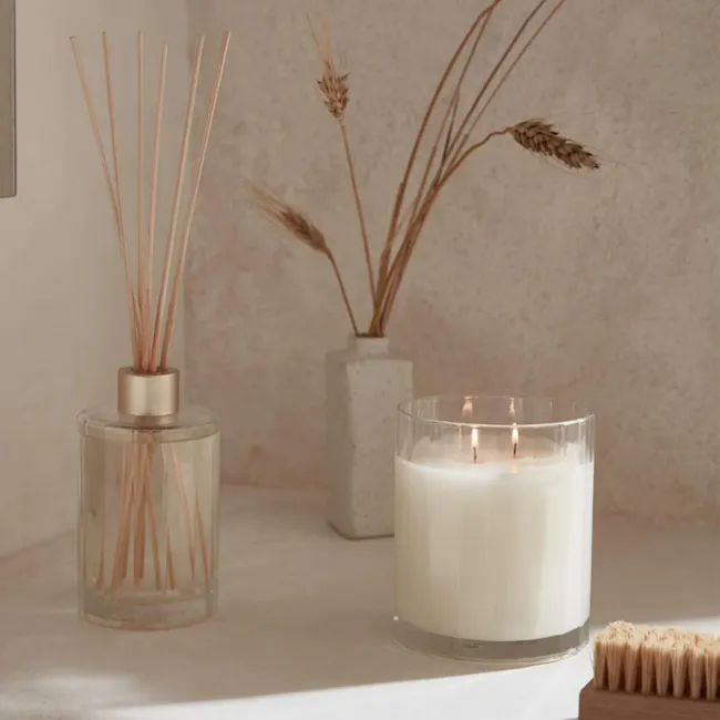 Circa Soy Candle - Sea Salt & Vanilla (2 Sizes) - 2 - glass jar with wooden sticks, white candle with flame, textured wall