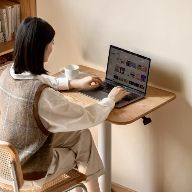 Easton Adjustable Table 0.6m - Oak, White - 2 - woman, sitting, laptop, typing, browsing, social media, website, desktop