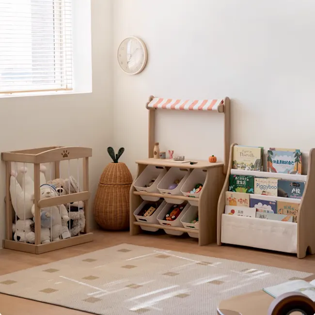 Micah Wooden Kids Toy Grocer Stand - 7 - Wooden crib with stuffed animals, baby toys, and books, soft beige rug, white clock