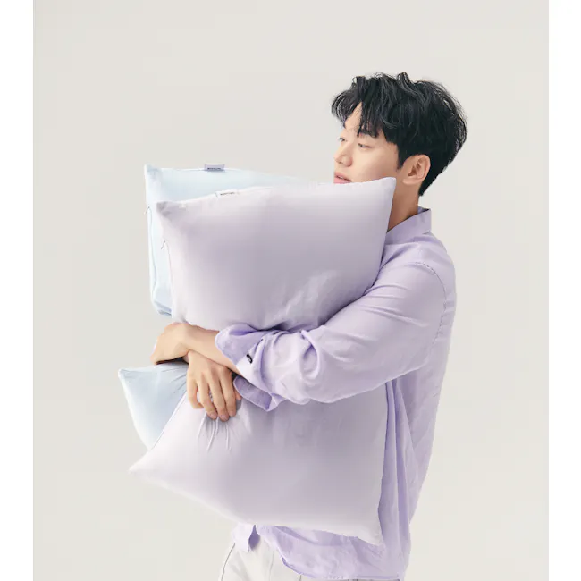 Bodyluv Addiction Cotton Ball Pillowcase - Lavender - 3 - Light purple shirt, light blue pillow, person holding pillow