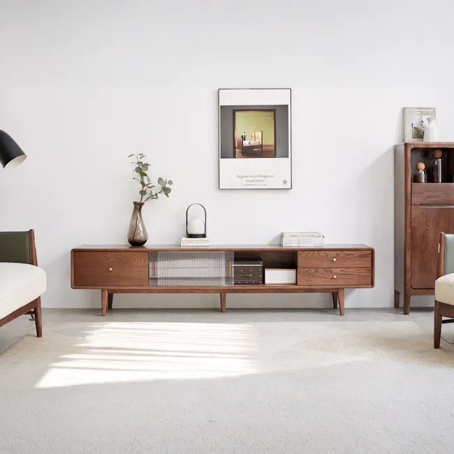 Lucia TV Console 2m - 3 - Wooden side table with glass container, green cushion chair, black lamp, white vase with green
