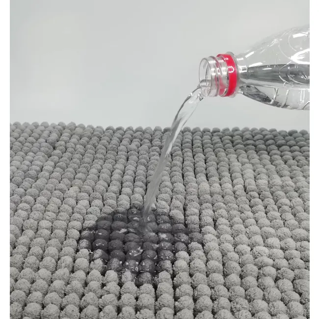 Cora Chenille Bath Mat - Light Grey - 4 - Clear plastic bottle, water pouring, gray textured surface, droplets forming