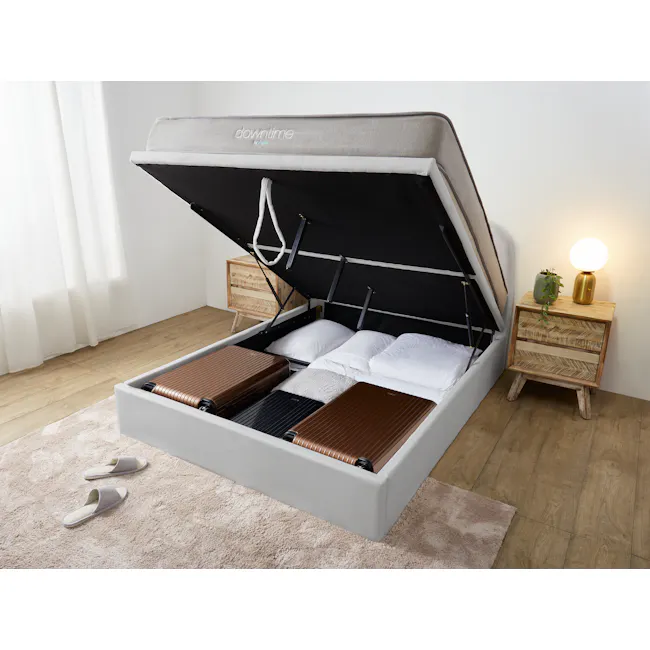 Nolan Queen Storage Bed - Silver Fox - 3 - Modern bedroom with compact bed, white and brown luggage, wooden nightstand, soft