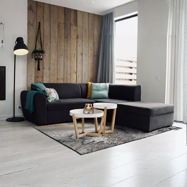 Torino Low Pile Rug - Swirl (3 Sizes) - 2 - Wooden accent wall, black sofa, teal and yellow pillows, modern decor, floor