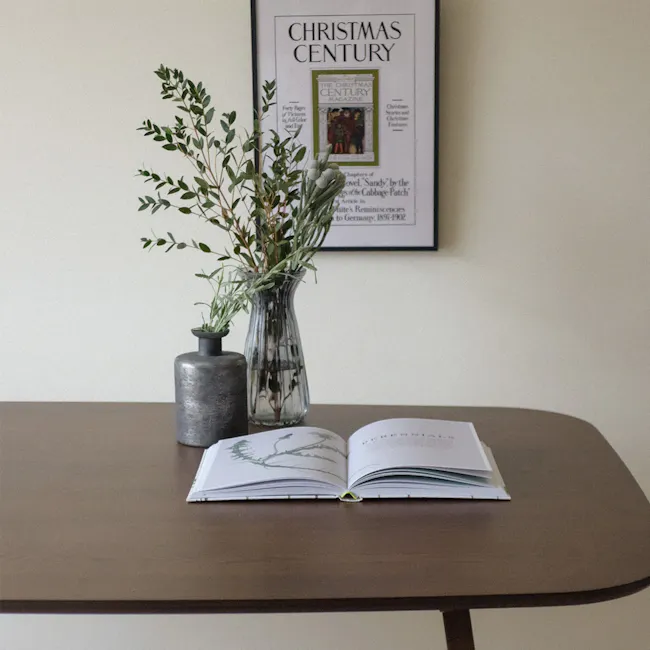 Anzac Dining Table 1.6m - Cocoa - 4 - vase with greenery, book with intricate design, open book with pages, magazine on