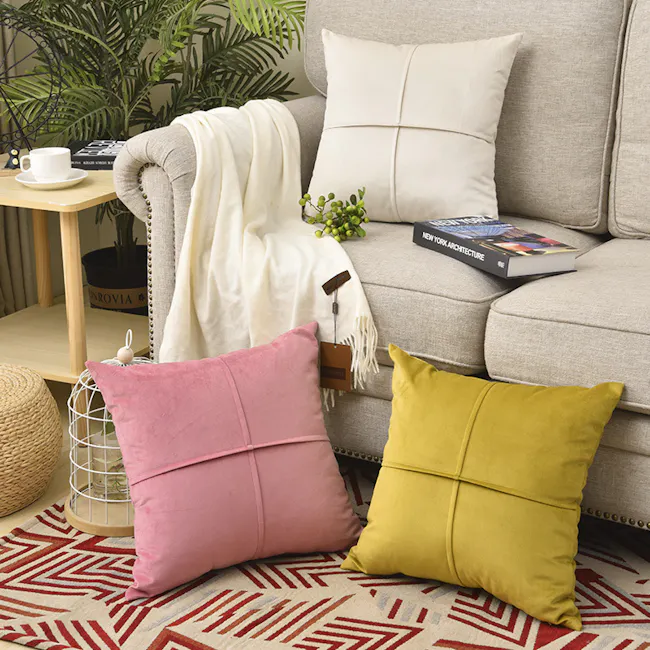 Ava Cushion - Off White - 4 - Cream sofa, white throw blanket, green plants, beige pillows, geometric pattern rug, wooden