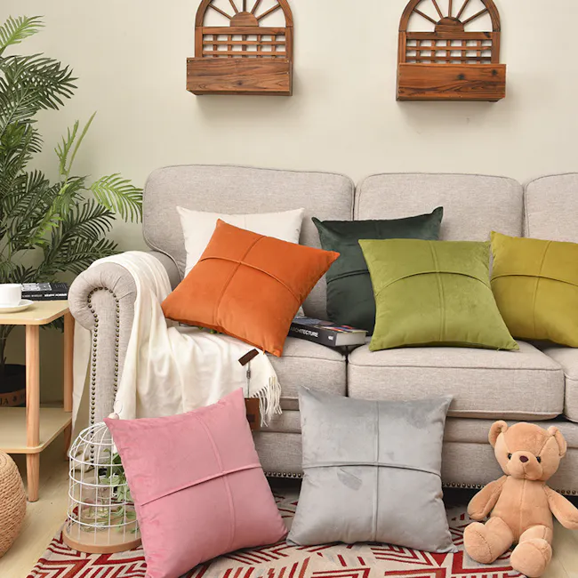 Ava Cushion - Off White - 5 - Light gray sofa, wooden wall-mounted shelves, orange, green, and white pillows, and gray