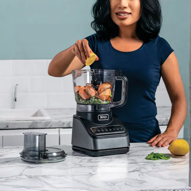 Ninja Professional Food Processor - 2 - woman preparing ingredients, lemon on kitchen counter, kitchen blender, black
