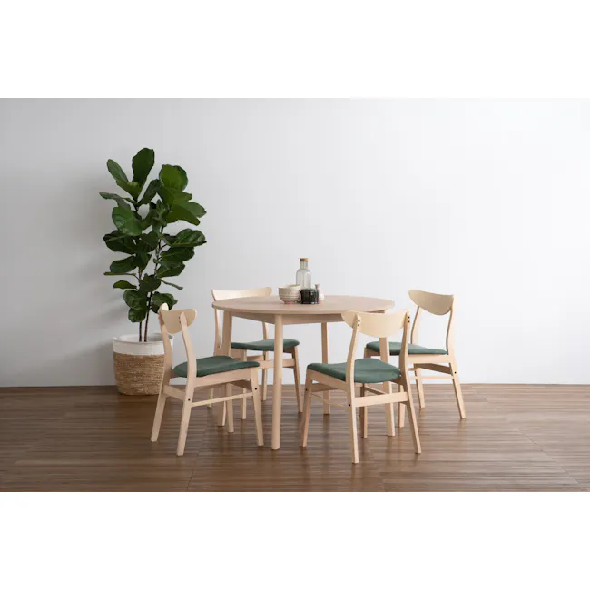 Sergio Round Dining Table 1m - Milk Oak - 2 - Light wooden dining table, four chairs with green cushions, minimalist