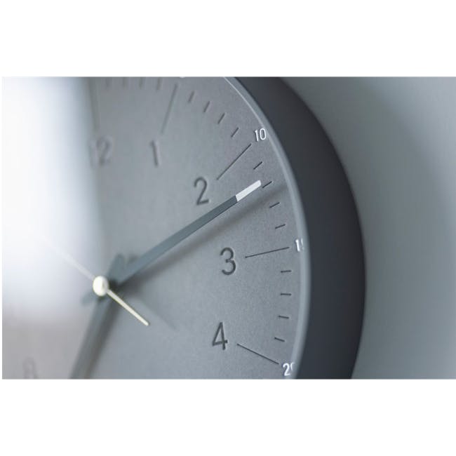 Essent Clock - Gray - 3 - Close-up view of a digital clock face, Minimalistic design with modern clock hands, Sharp focus on