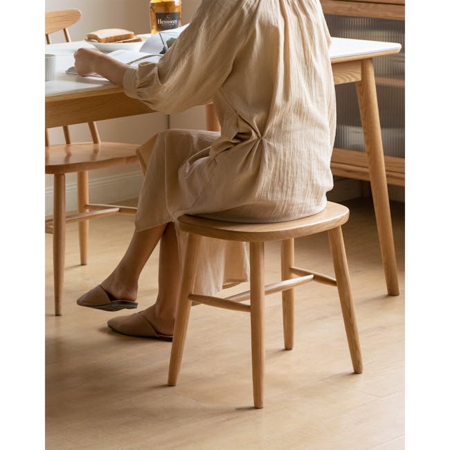 Pete Stool - Oak - 2 - Wooden dining table, person sitting, beige dress, wooden chair, wooden floor, wooden table, wooden