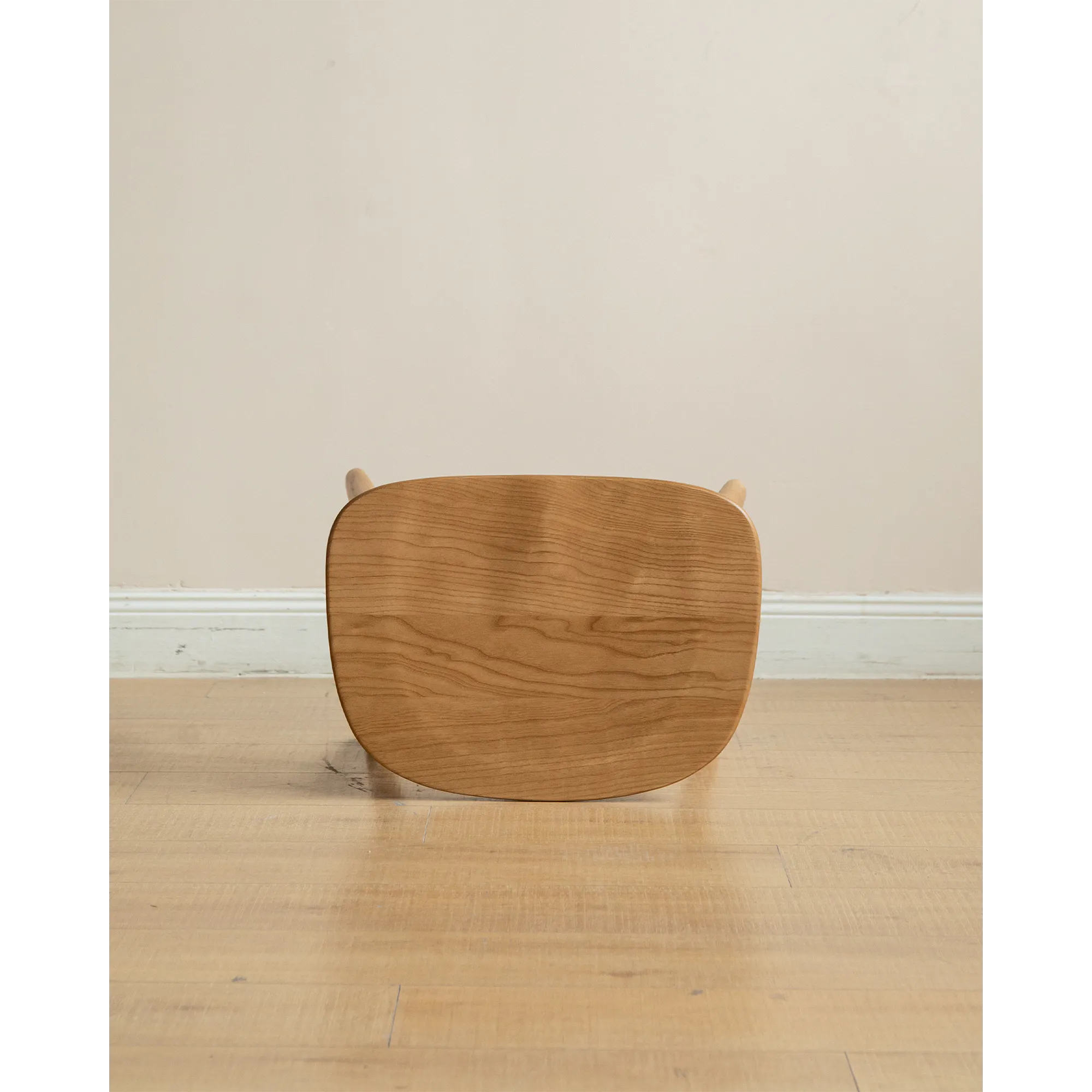 Pete Stool - Oak - 12 - Wooden stool, minimalist design, round top, natural wood finish, light beige wall, wooden legs