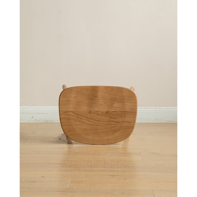 Pete Stool - Oak - 12 - Wooden stool, minimalist design, round top, natural wood finish, light beige wall, wooden legs