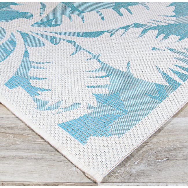 Coastal Flora Flatwoven Rug - Ivory Turquoise (3 Sizes) - 4 - White textured rug with blue leaf patterns, light wooden floor