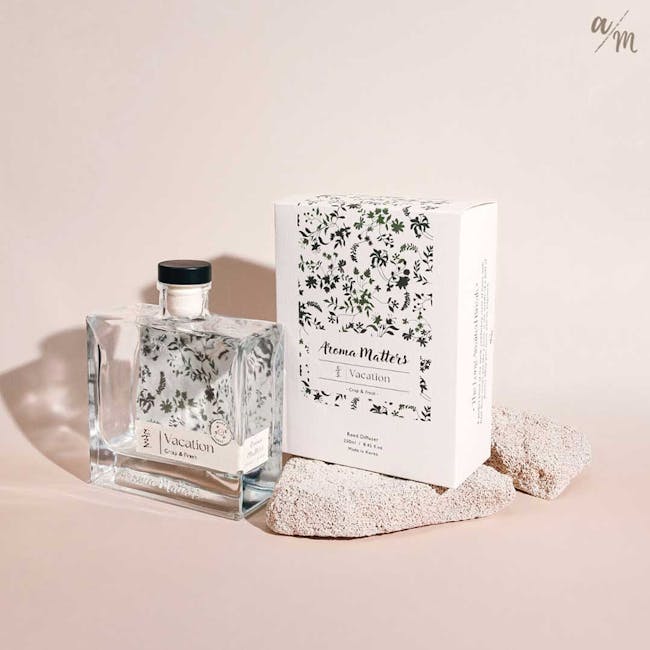 Aroma Matters Reed Diffuser - Vacation (2 Sizes) - 10 - Clear glass bottle with black cap labeled "Vacation, " floral