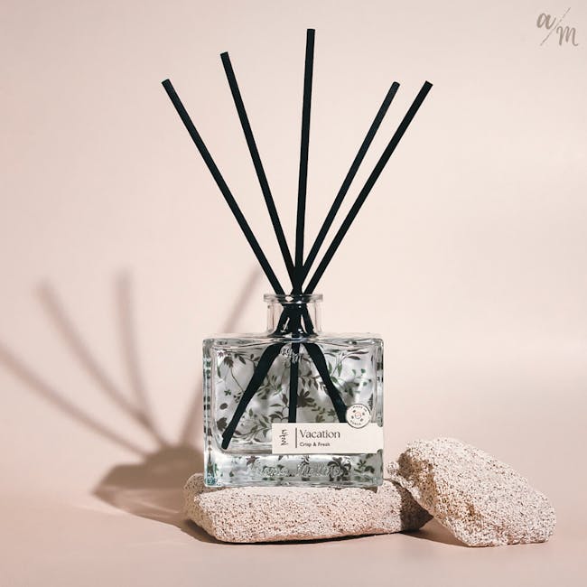 Aroma Matters Reed Diffuser - Vacation (2 Sizes) - 2 - Glass perfume bottle with black sticks, floral design, "Vacation"