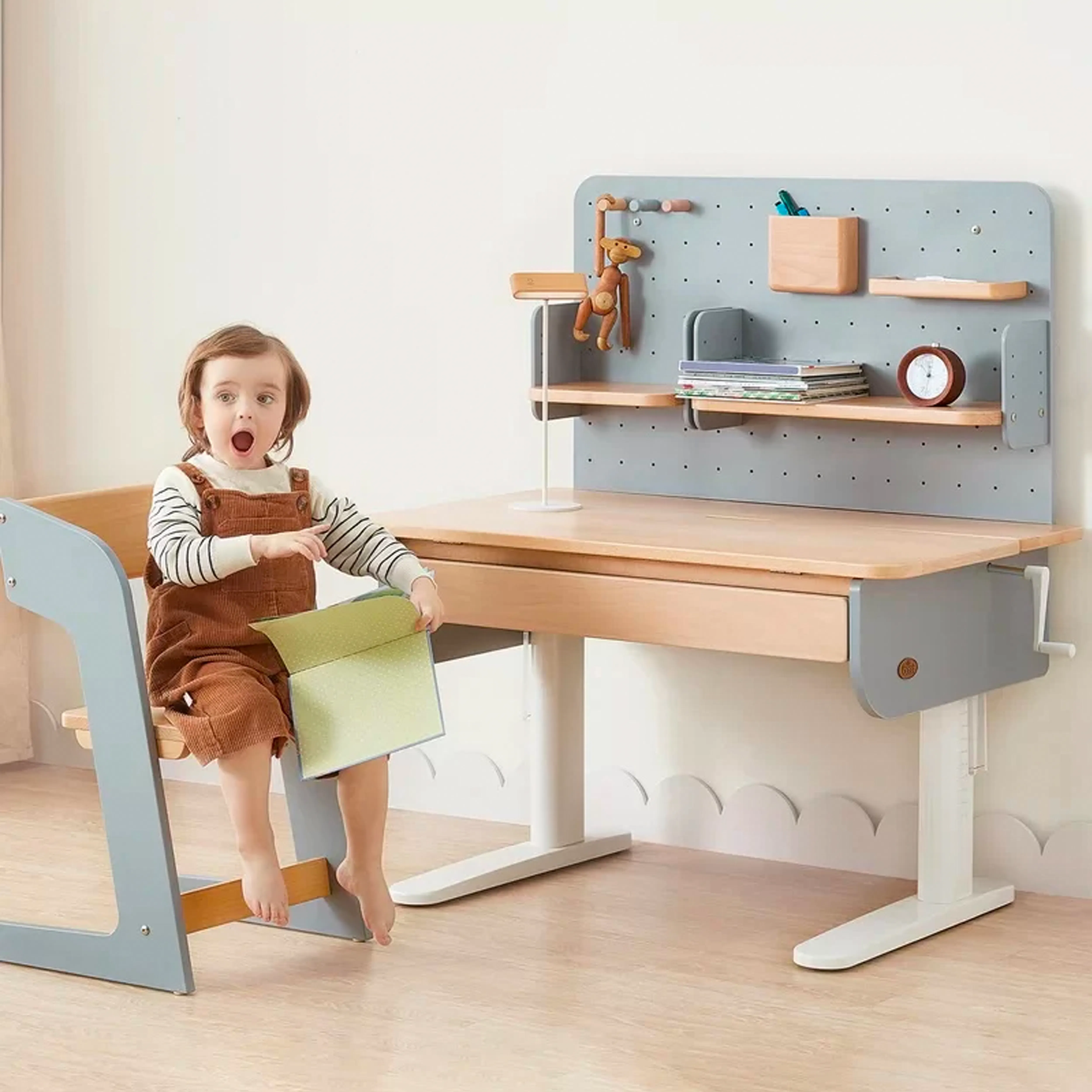 Boori Ergonomic Desk with Pegboard Hutch 1m - Cherry - 11 - child sitting on wooden chair, holding green book, barefoot