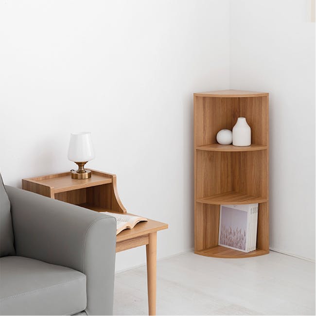 Sholid 3 Tier Corner Shelf 0.3m - 5 - Wooden side table with white lamp, gray sofa, light wooden shelf, open book on table