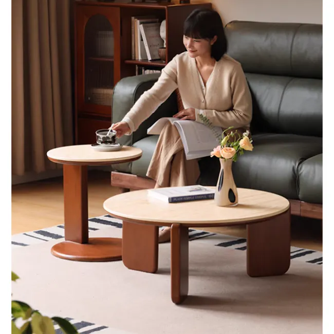 Blair Round Coffee Table - Travertine (Sintered Stone) - 4 - Wooden coffee table, woman reading, open book, beige sweater