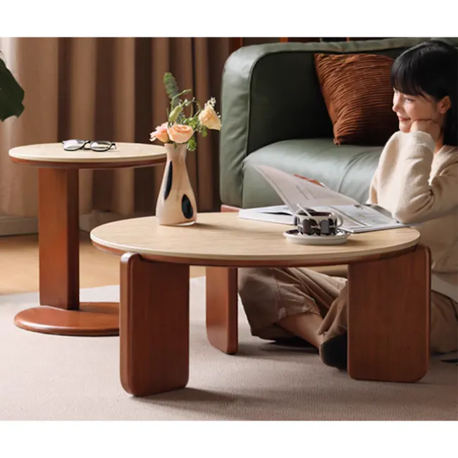 Blair Round Coffee Table - Travertine (Sintered Stone) - 11 - Modern living room, cozy setting, woman reading, comfortable