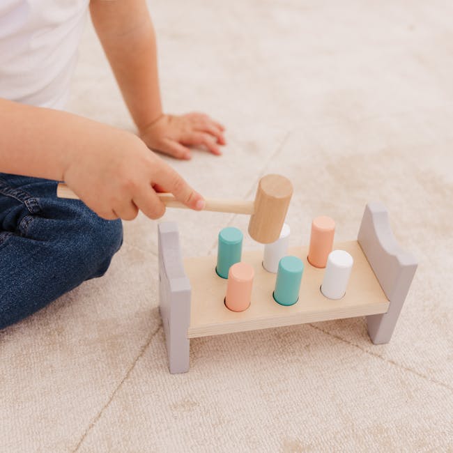 Bubble Wooden Hammer Bench - 5 - child playing with wooden toy, hand holding wooden mallet, child sitting on carpet