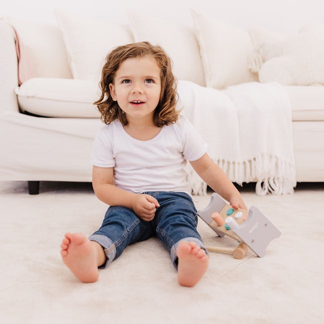 Bubble Wooden Hammer Bench - 7 - White couch, child sitting, curly hair, white pillows, soft lighting, white blanket, wooden