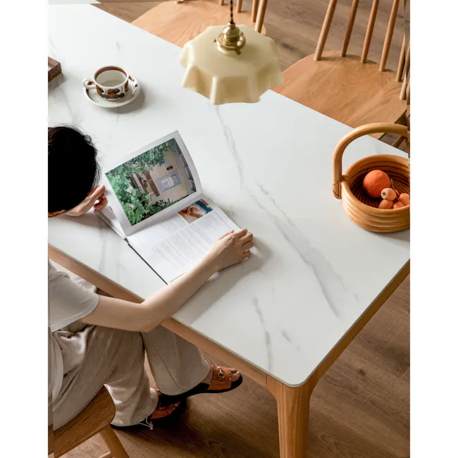 Adelyn Dining Table 1.2m (Sintered Stone) with 4 Niel Chairs in Oak - 3 - White marble table, wooden chair, person reading