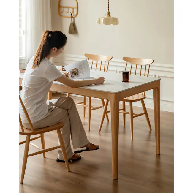 Adelyn Dining Table 1.2m (Sintered Stone) with 4 Niel Chairs in Oak - 4 - Light streaming through window, woman reading