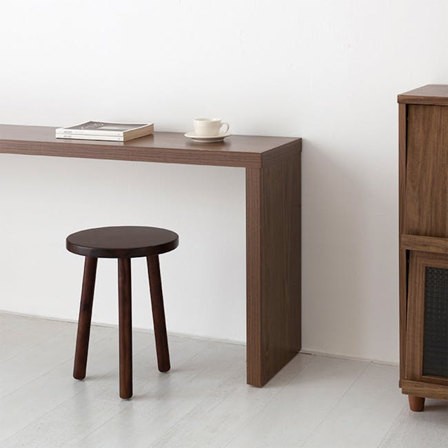 Vezzo Stool Side Table - 2 - Wooden desk, minimalist design, dark wood finish, small round stool, white cup and saucer, book