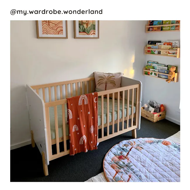 Natty Boori Cot Bed - Barley & Almond - 2 - Wooden crib with rainbow-patterned blanket, children's bookshelf with colorful