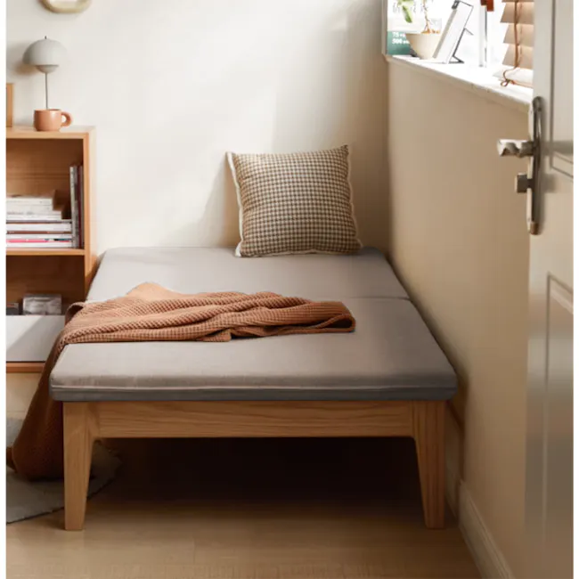 Mariel Lounge Sofa Bed - Chestnut - 6 - Wooden bed with gray mattress, cozy throw blanket, soft beige pillow, wooden