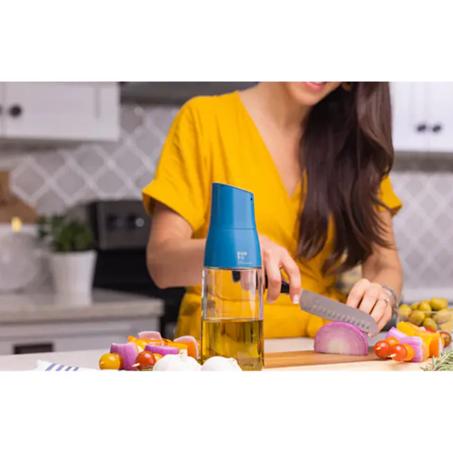 Zuutii Drip-Free Oil Carafe - Deep Blue - 7 - yellow shirt, kitchen scene, woman cooking, cutting vegetables, fresh produce