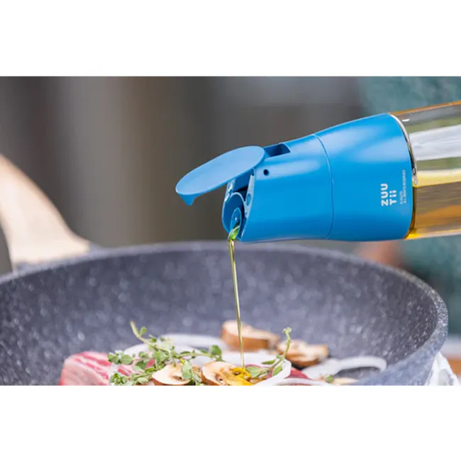 Zuutii Drip-Free Oil Carafe - Deep Blue - 2 - Golden olive oil pouring from a sleek blue bottle, culinary scene with fresh