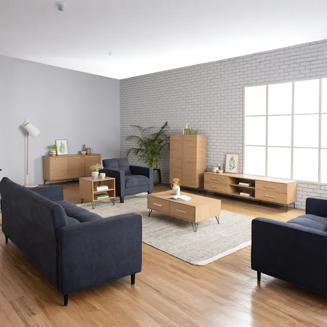 Sandra Bedside Table - Oak - 2 - Modern living room with gray brick wall, wooden furniture, gray armchair, blue sofa, wooden