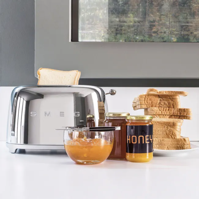 Smeg 2-Slice Toaster - Chrome - 2 - smeg toaster, honey, jam, sliced bread, stack of bread, honey jar, honey dipper, honey