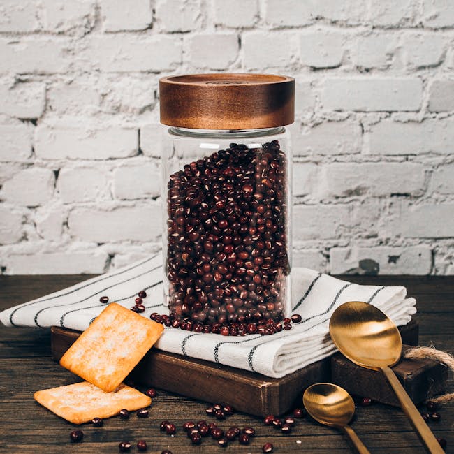 Table Matters Taikyu Acacia Clear Storage Jar (3 Sizes) - 4 - Glass jar filled with dark red beans, white cloth with black