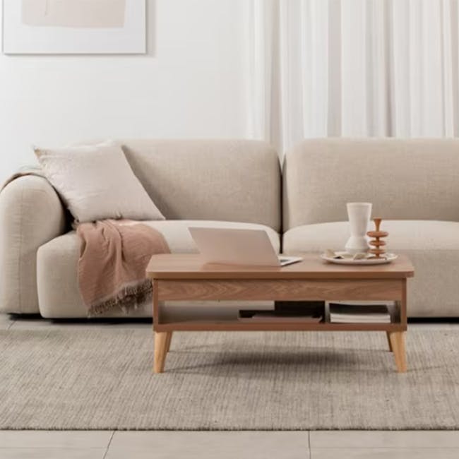 Muna Lift-Up Coffee Table - Natural - 3 - Cream-colored sofa, minimalist coffee table, light beige cushions, cozy living