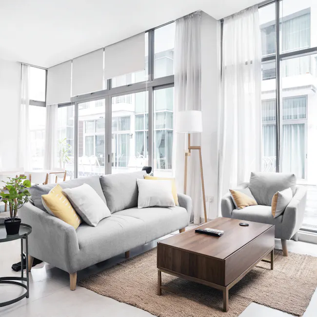 Hana 3 Seater Sofa - Light Grey - 9 - Modern living room with large windows, minimalist furniture, light gray sofa, yellow