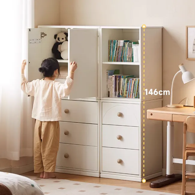 Mika Kids 2 Door Cabinet - 9 - child, standing, wardrobe, open, bookshelf, teddy bear, beige pajamas, wooden dresser, white