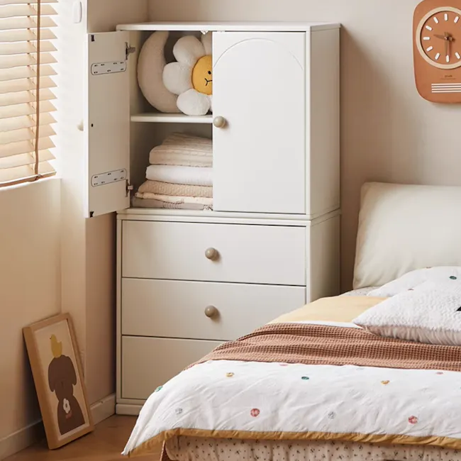 Mika Kids 2 Door Cabinet - 5 - White dresser with open doors, neatly folded towels, plush flower, clock on wall, framed