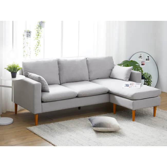 Alicia L-Shaped Sofa - Slate - 3 - Light gray sofa, wooden legs, white and gray pillows, round rug, white and gray throw