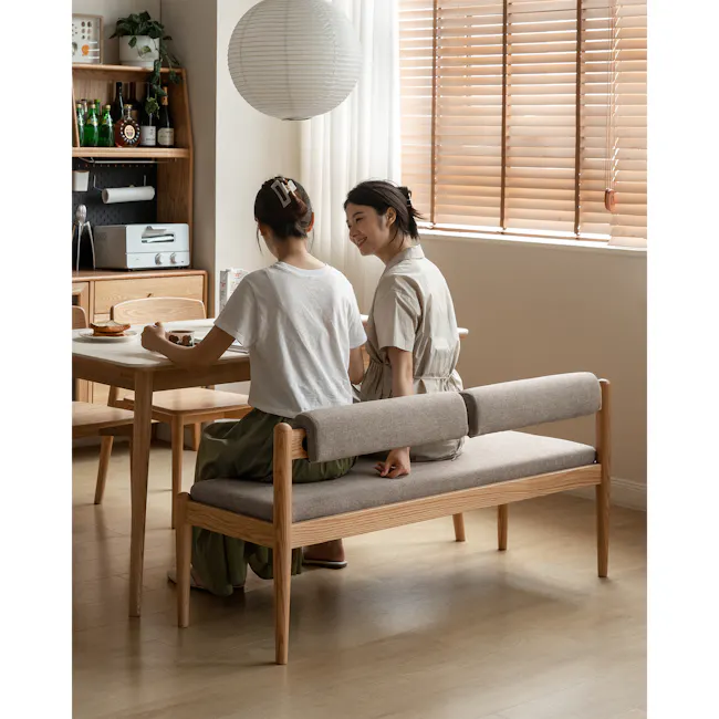 Niel Bench 1.45m - Oak, Chestnut - 4 - Wooden dining table, two women sitting, casual attire, wooden bench, natural light
