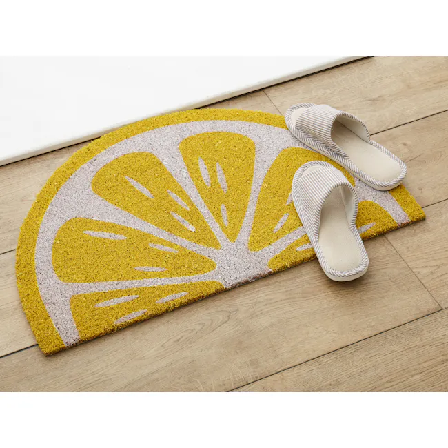 Lemon Coir Door Mat - 2 - Yellow and white patterned rug, wooden floor, slippers, cozy atmosphere, modern design, soft