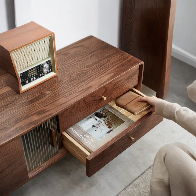 Lucia TV Console 2m - 9 - Vintage radio, wooden side table, brown wood finish, magazine, leather wallet, person's hand, open